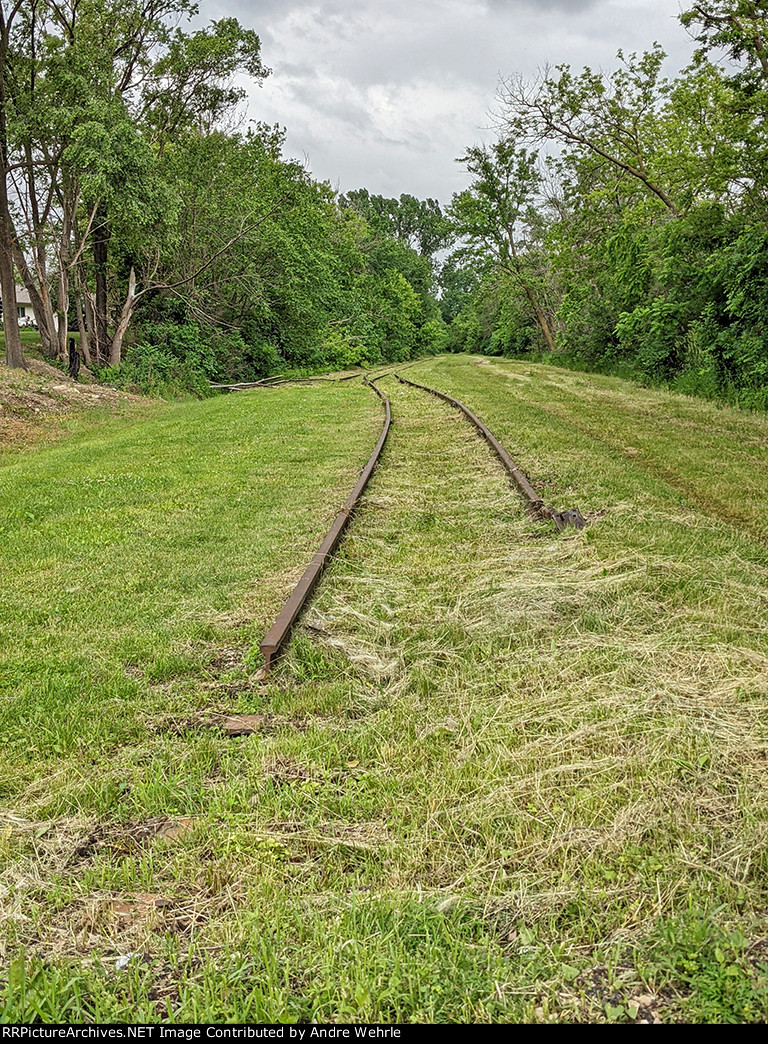 Remains of former CGW rails stubbed off in the grass south of 7th St. SE